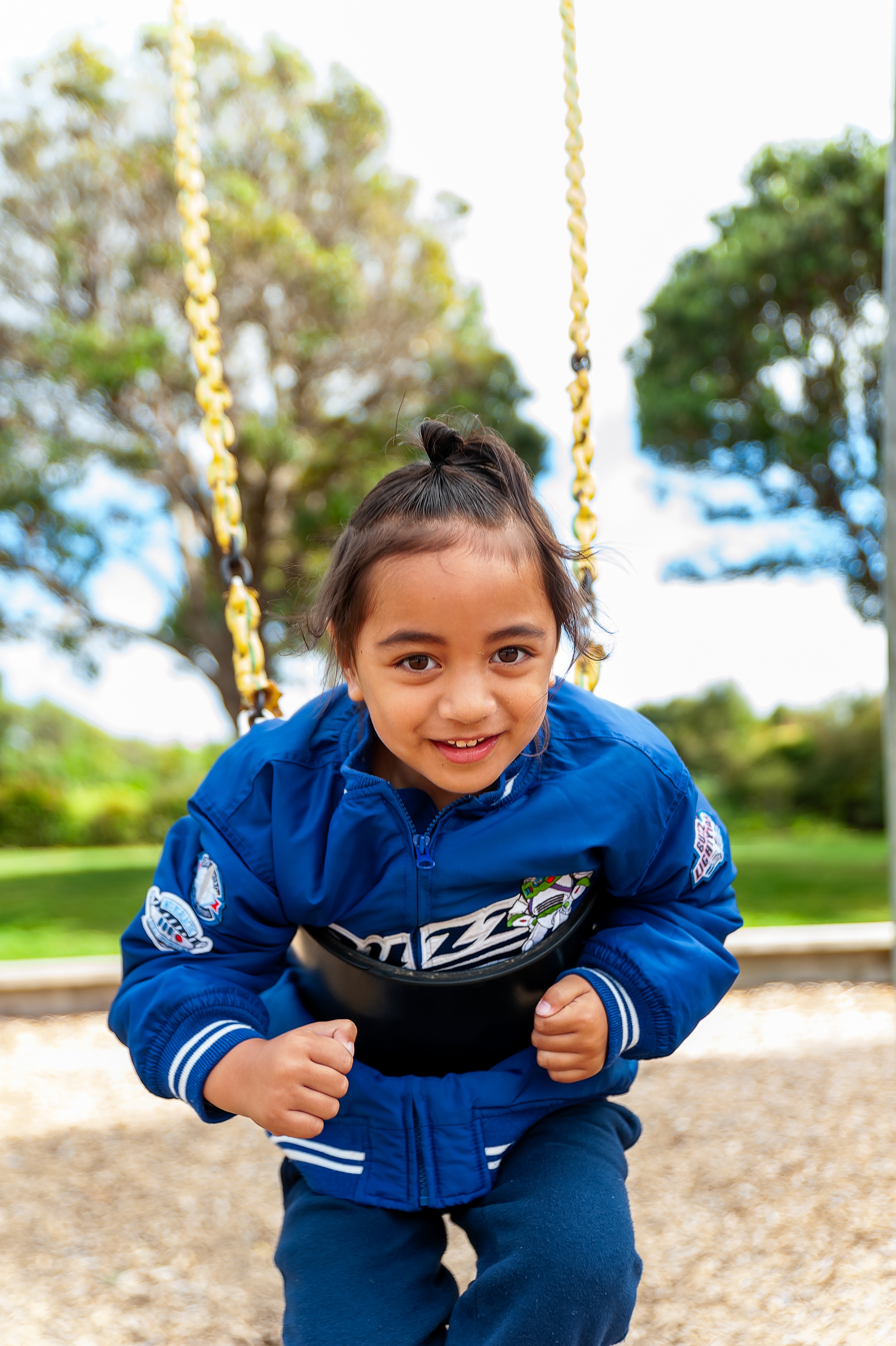 Happy child swinging on a swing